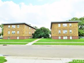 Anoka apartment for rent - Two identical brick apartment buildings sit side by side.