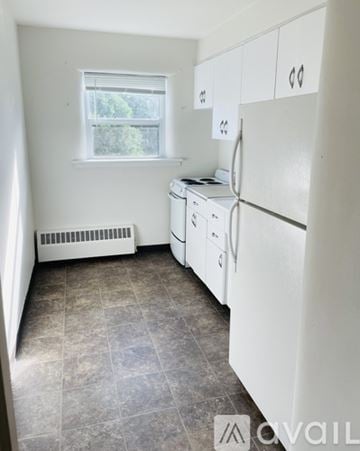 Anoka apartment for rent - A kitchen with white appliances and a window.