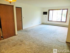 Minneapolis apartment for rent - A room with a carpeted floor, a door, and a window.