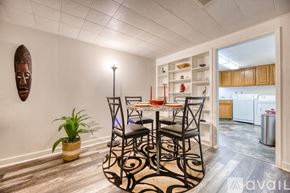 Lakewood townhouse for rent - A dining room with a table set for four and a plant on the floor.