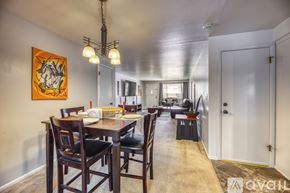 Lakewood townhouse for rent - A dining room with a wooden table and chairs.