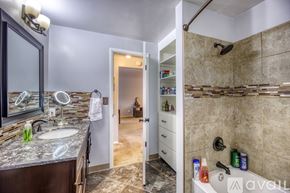 Lakewood townhouse for rent - A bathroom with a shower, sink, and mirror.