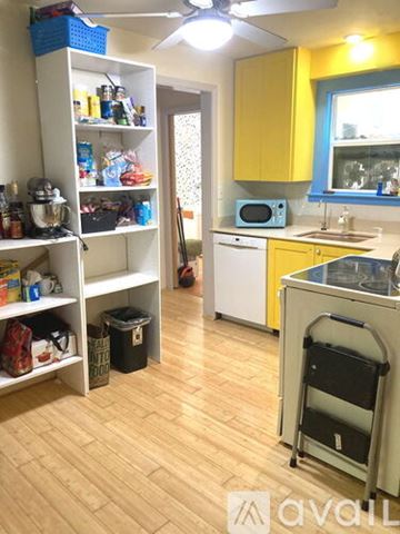Austin apartment for rent - A kitchen with yellow cabinets and a white fridge.