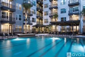 Dallas apartment for rent - A swimming pool in front of a multi-story apartment building.