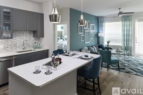 Dallas apartment for rent - A modern kitchen with a dining area in the foreground.