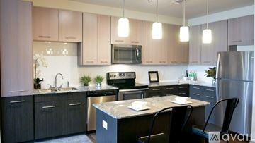 Little Elm apartment for rent - A kitchen with a black countertop and a sink.