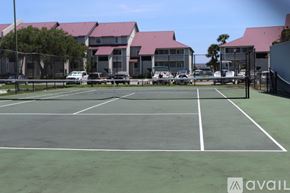 Charleston apartment for rent - A tennis court with a building in the background.