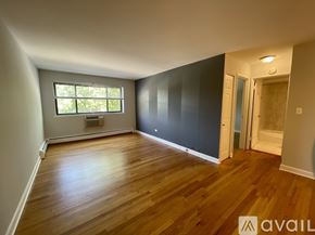 Chicago apartment for rent - A room with wooden floors and a window.