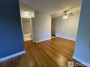 Chicago apartment for rent - A room with wooden flooring and a ceiling fan.