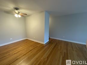 Chicago apartment for rent - A room with wooden flooring and a ceiling fan.