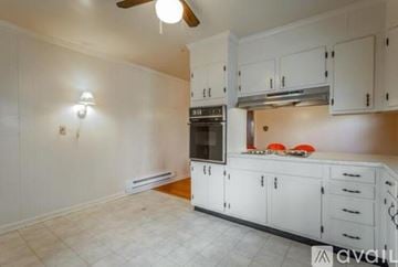 Signal Mountain house for rent - A kitchen with white cabinets and a black oven.