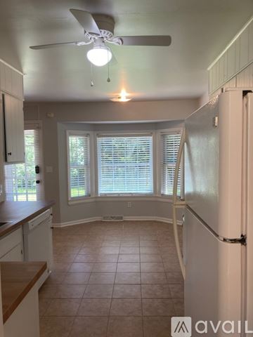 Mount Pleasant house for rent - A kitchen with white cabinets and a white refrigerator.