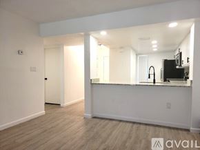 Orlando apartment for rent - A spacious, empty room with a bar area and a television.