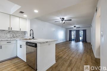 Orlando apartment for rent - A kitchen with white cabinets and a marble countertop.