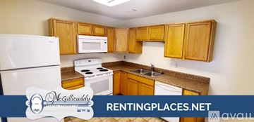 Augusta apartment for rent - A kitchen with wooden cabinets and white appliances.