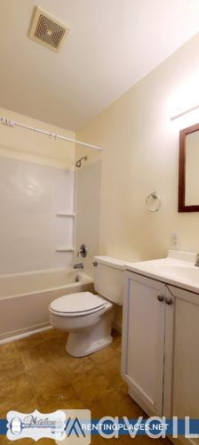 Augusta apartment for rent - A kitchen with wooden cabinets and a white refrigerator.