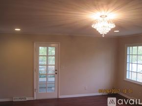 Carbondale house for rent - A room with a door and a chandelier.