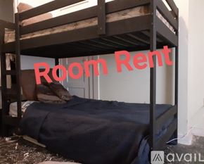 New Orleans house for rent - A bunk bed with a blue blanket and pillow is in a room for rent.