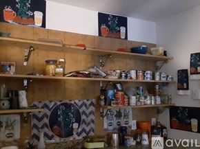 New Orleans house for rent - A kitchen pantry with a lot of food items and jars.
