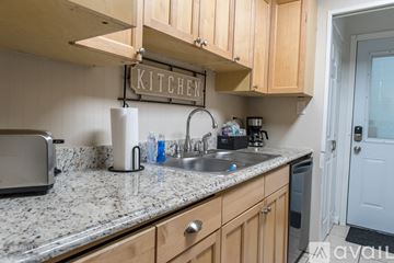 Shreveport townhouse for rent - A kitchen with wooden cabinets and granite countertops.