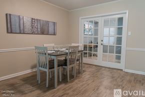 Shreveport townhouse for rent - A dining room with a table set for two and a painting on the wall.