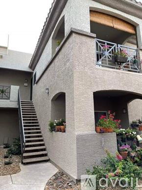 Scottsdale apartment for rent - A small house with a balcony and flower pots.