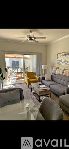 Scottsdale apartment for rent - A living room with a glass table and a grey couch.