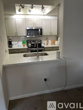 Scottsdale apartment for rent - A kitchen with a stove top oven and a microwave above it.