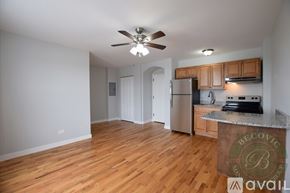 Chicago apartment for rent - A kitchen with wooden floors and a ceiling fan.