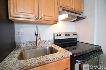 Chicago apartment for rent - A kitchen with a stove top oven and a granite counter top.