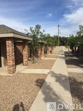 Farwell apartment for rent - A sunny day at the brick building with a clear blue sky.