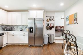 Atlanta house for rent - A kitchen with a stainless steel refrigerator and white cabinets.