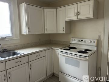 Chestertown house for rent - A white kitchen with a stove and cabinets.