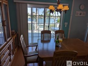 Madeira Beach house for rent - A dining room with a table set for two and a view of the water outside.