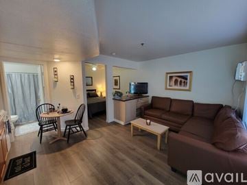Bullhead City apartment for rent - A living room with a brown couch and a wooden coffee table.