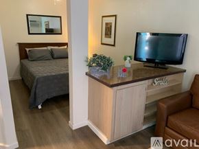 Bullhead City apartment for rent - A bedroom with a bed, a desk with a television, and a chair.