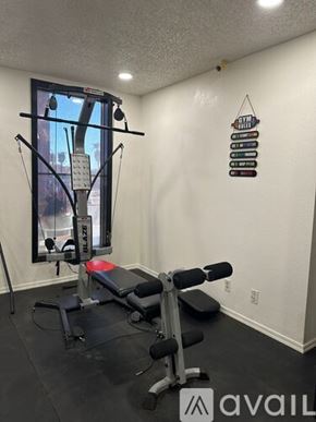 Bullhead City apartment for rent - A gym room with a weight bench and a mirror.