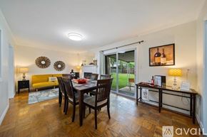 Tulsa house for rent - A dining room with a wooden table and chairs.