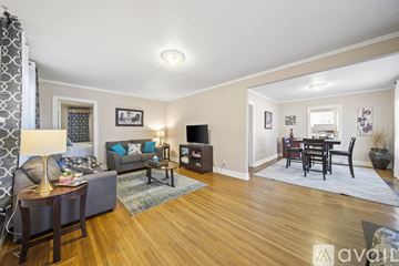 Tulsa house for rent - A living room with a grey couch and a wooden floor.
