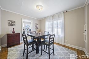 Tulsa house for rent - A dining room with a table and chairs.