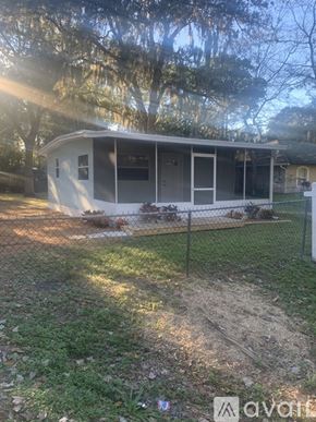 Holly Hill house for rent - A house with a fence and trees in the background.