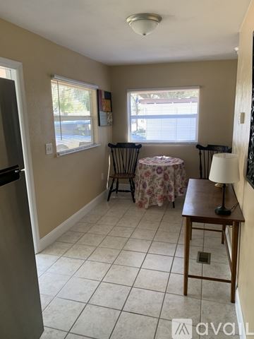 Holly Hill house for rent - A kitchen with a table and chairs by the window.