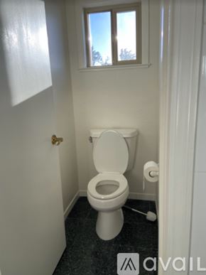 San Bruno apartment for rent - A white toilet in a small bathroom with a window.