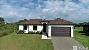 Naples apartment for rent - A house with a white exterior and a black garage door is for sale.