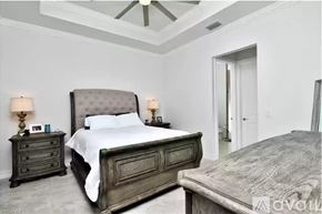 Naples apartment for rent - A bedroom with a large bed and a smaller bed in the corner.