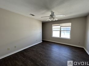 Waco apartment for rent - A room with a ceiling fan and a window.
