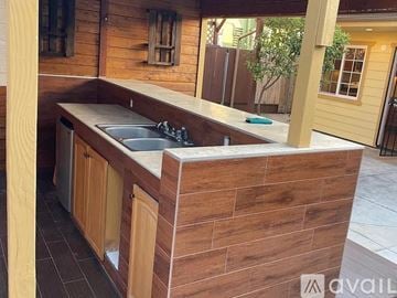 San Diego house for rent - A kitchen with wooden cabinets and a sink under a counter.
