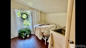 Newburyport apartment for rent - A dining area with a table and chairs is visible through a window.