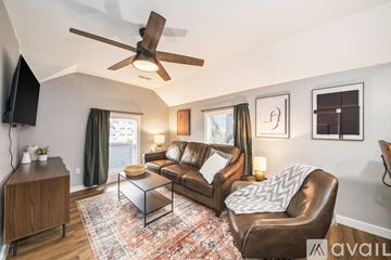 Grand Rapids apartment for rent - A living room with a brown leather chair and a glass coffee table.