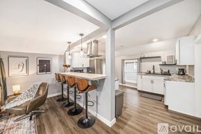 Grand Rapids apartment for rent - A kitchen with a bar area and a dining table.